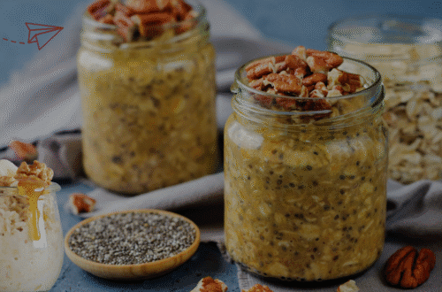 Overnight oats with chia seeds and pecan topping in jars for high protein meal prep.